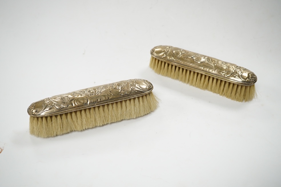 An Edwardian silver mounted four piece mirror and brush set, Birmingham, 1901. Condition - poor